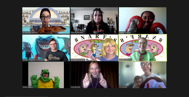 Screenshot of Zoom call with CREEC staff dressed up for Halloween. On the top row, L-R: Ana as a baker on the Great British Baking Show, Pilar as Lydia from Beetlejuice, and Mikhal as a boxer. On the second row, Kyle as a shark, Parima and Caroline as characters from the Snarf's Sandwiches logo. On the third row, Martie as a turtle, the interpreter, and Liz holding Frida dressed as a donut.